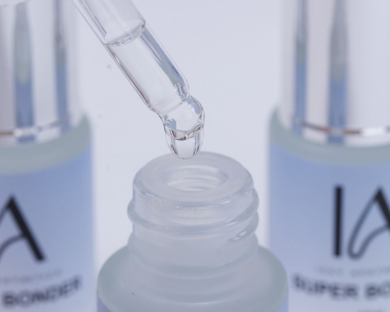 Close-up of a dropper bottle with a blurred background